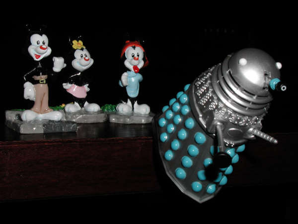 The Warner Brothers and Sister push Mr Dalek off the cupboard.